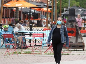 People are seen enjoying outdoor patios set up along Kensington Rd. NW on a warm afternoon. Wednesday, June 23, 2021.