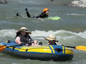 People are seen enjoying a hot day along the Bow River at Harvie Passage. Wednesday, June 2, 2021.