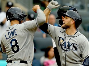 Jun 3, 2021; Bronx, New York, USA; Tampa Bay Rays designated hitter Austin Meadows (17) is congratulated by  second baseman Brandon Lowe (8) after hitting a two run home run against the New York Yankees during the fourth inning at Yankee Stadium. Mandatory Credit: Andy Marlin-USA TODAY Sports ORG XMIT: IMAGN-432491