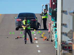Calgary police traffic unit officers investigate a collision where a tow truck driver was struck by a car while working in the 5800 block of 11th street N.E. on Wednesday, June 16, 2021.