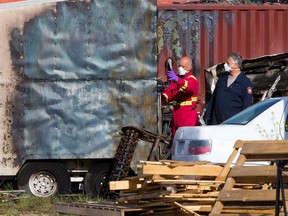 Fire and police investigators examine the scene of an early morning trailer fire that left one person with serious injuries on Tuesday, June 22, 2021. The fire occurred in an industrial yard in the 1200 block of Moraine Road N.E.

Gavin Young/Postmedia