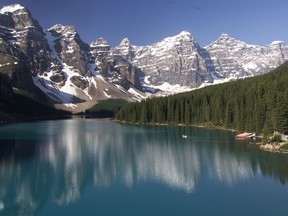 A lone canoe makes its way across Moraine Lake in this Herald file photo. Banff National Park will now require non-motorized boat users to fill out a self-certification permit ensuring their watercraft has been cleaned and dried.