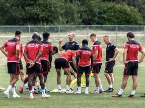 Cavalry FC  general manager and head coach Tommy Wheeldon Jr. speaks to his team in a team huddle during training in Prince Edward Island at the Canadian Premier League Island Games in the summer of 2020.