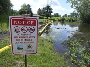 A sign at the confluence of Talmadge Creek and the Kalamazoo River warns residents of Marshall, Mich. On July 26, 2010, hundreds of thousands of gallons of oil from a ruptured pipeline operated by Enbridge Inc. spilled into the Kalamazoo. The current debate over Line 5 goes back to this disaster, says columnist Gerry Kruk.