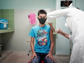 Cristian Artimbau, 14, gets a dose of the Soberana 02 vaccine during its clinical trials at a hospital amid concerns about the spread of the coronavirus disease (COVID-19) in Havana, Cuba, June 29, 2021.