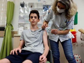 A teenager receives a dose of a vaccine against the coronavirus disease (COVID-19) as Israel urged more 12- to 15-year-olds to be vaccinated, citing new outbreaks attributed to the more infectious Delta variant, at a Clalit healthcare maintenance organisation in Tel Aviv, Israel June 21, 2021.