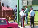 Calgary police investigate the killings of Barry Christian Buchart and Trevor Thomas Deakins at a fourplex on July 11, 1994.