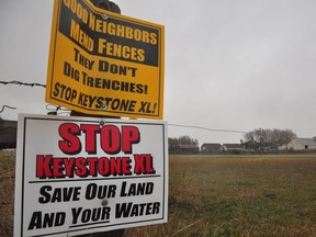 This file photo taken on April 17, 2013, shows signs attached to a fence on the property of Jim Tarnick, a farmer opposed to the Keystone XL pipeline in Fullerton, Nebraska.