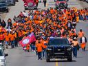 Members of Tsuut’ina Nation west of Calgary march on June 7, 2021, in memory of the 215 unmarked graves found at a residential school in Kamloops. 