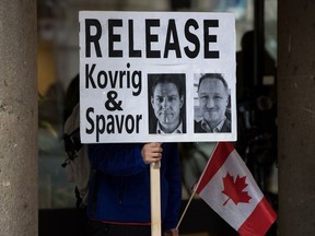 A man holds a sign calling for China to release detained Canadians Michael Kovrig and Michael Spavor, who have been held in China for more than two years.