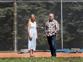 Leanne Ellis and Mark Yobb, both members of the Rutland Park Community Association, pose for a photo in Richmond Green Park. The two are fighting City Hall as the city is planning on selling off two heavily used baseball diamonds in the park.