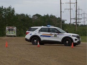 An ambulance drives away from a police blockade west of Edmonton on Saturday, June 5, 2021.