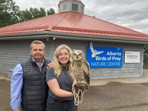 Colin Weir and daughter Aimee with a young great horned owl, at the Alberta Birds of Prey Foundation Nature Centre in Coaldale, Alberta.