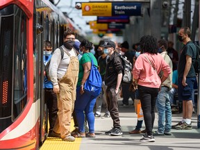 Calgary transit riders wear masks while using the CTrain at City Hall station on Wednesday, June 23, 2021.
