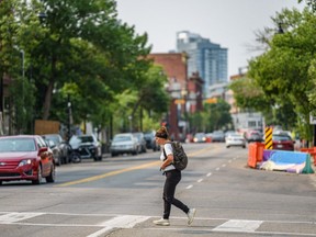 A pedestrian crosses 9 Ave. S.E. on Wednesday, July 28, 2021.