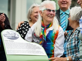 Lois Szabo is surrounded by friends and family at the opening of the commons named after her in Calgary’s Beltline on Wednesday, July 21, 2021.