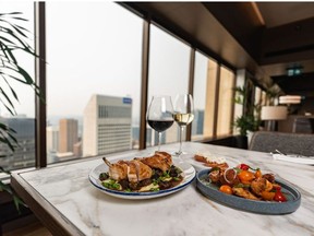 Crispy half chicken, tomato and brioche salad, and potato doughnuts at Major Tom, a new restaurant at the top of Stephen Avenue Place, were photographed on Thursday, July 29, 2021. Azin Ghaffari/Postmedia
