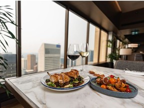 Crispy half chicken, tomato and brioche salad, and potato doughnuts at Major Tom, a new restaurant at the top of Stephen Avenue Place, were photographed on Thursday, July 29, 2021.