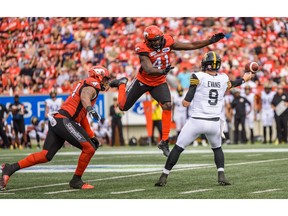 Calgary Stampeders Mike Rose and Cordarro Law try to block Hamilton Tiger-Cats Quarterback Dane Evans during the regular season action at McMahon Stadium in Calgary on Saturday, September 14, 2019.