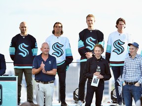 SEATTLE, WASHINGTON - JULY 21: (Back Row L-R) Mark Giordano, Chris Tanev, Jamie Oleksiak, Haydn Fleury, Jordan Eberle and Chris Drieger are introduced as members of the Seattle Kraken during the 2021 NHL Expansion Draft at Gas Works Park on July 21, 2021 in Seattle, Washington. The Seattle Kraken is the National Hockey League's newest franchise and will begin play in October 2021.