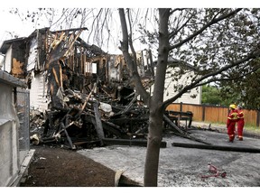 The rear of a house in Chestermere, AB, east of Calgary is shown on Friday, July 2, 2021. The overnight fire severely damaged the home and a number of residents are deceased.