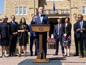 Premier Jason Kenney speaks alongside new cabinet members after a swearing in ceremony at Government House in Edmonton, on Thursday, July 8, 2021. Government ministers and associate ministers were sworn in as part of a cabinet shuffle.