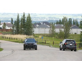 Calgary police hold the scene in the Crestmont neighborhood in southwest Calgary on Thursday, July 8, 2021. A man and his dog were shot on Wednesday afternoon.