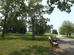 Beverly Sandalack enjoys the greenery in Richmond Green park in southwest Calgary on Thursday, July 15, 2021.