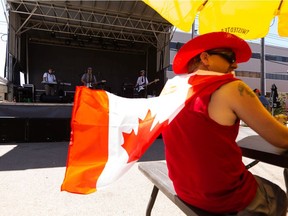 Music fans take in drinks and 1980s music from Rubix Cubed on the patio during the Blues On Whyte's 10th anniversary Block Party in Edmonton, on Thursday, July 1, 2021.