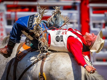 Richmond Champion of Stevensville, MT,on horse called Make Up Face during the bareback event at the Calgary Stampede rodeo on Monday, July 12, 2021. Al Charest / Postmedia