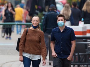 Calgarians walk in downtown Calgary after city council voted to rescind the mandatory masking bylaw in the city. Mandatory masking for transit and inside city owned and operated facilities will remain for the time being. Council voted on Monday, July 5, 2021.