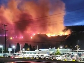 A wildfire burns on a hill in Kamloops, B.C., on July 1, 2021, in this screen grab obtained from a social media video.