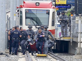 Calgary police take a person into custody at the Sirocco CTrain station on Wednesday, July 7, 2021.