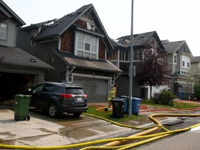 Fire crews on the scene of a blaze that damaged two homes on Auburn Glen Lane S.E. Friday afternoon, July 30, 2021.