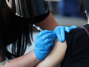 A student receives a dose of a COVID-19 vaccine on the campus of the University of Memphis in Memphis, Tennessee, U.S., on July 22, 2021.