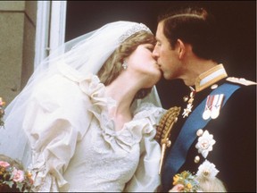In this file photo taken on July 29, 1981 Charles, Prince of Wales, kisses his bride, Lady Diana, on the balcony of Buckingham Palace when they appeared before a huge crowd after their wedding in St Paul's Cathedral. (Pool photo/AFP)