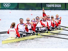 Canada's gold medallists (from right to left) Lisa Roman, Kasia Gruchalla-Wesierski, Christine Roper, Susanne Grainger, Andrea Proske, Madison Mailey, Sydney Payne Avalon Wasteneys and coxswain Kristen Kit pose in their boat following the women's eight final during the Tokyo 2020 Olympic Games at the Sea Forest Waterway in Tokyo on July 30, 2021. (Photo by Charly TRIBALLEAU / AFP)