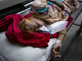 A COVID-19 patient waits to be transferred to a different hospital because the ICU at the hospital she was admitted to was full, on July 25, 2021 in Dhaka, Bangladesh.