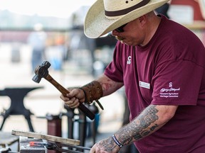 Blacksmith Chris Rowan makes a hoof pick at the Calgary Stampede’s blacksmith demonstrations on July 15, 2021.