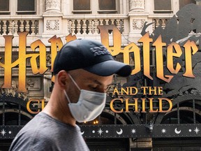 A man wearing a mask is photographed in the Theater District in Times Square, New York City, on Friday, July 30, 2021.