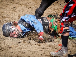 Bull-rider Josh Frost is stepped on by Billy Big Rigger after scoring an 83.5 on Day 5 of the bull-riding event at the Calgary Stampede rodeo on Tuesday.