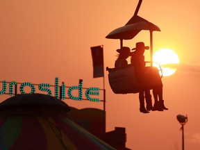 A smoky sunset warms the sky at the Calgary Stampede on   Thursday, July 15, 2021. 

Gavin Young/Postmedia