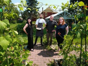 Tannis Baker, left and Rheannon Green, right, with the Alberta on the Plate festival stand with Rouge chefs Dean Fast and Paul Rogalski in the garden behind Rouge on July 22, 2021. Alberta on the Plate is a provincewide celebration of the incredible bounty grown and produced across Alberta. Rouge is one of the participating restaurants.

Gavin Young/Postmedia