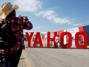 A woman takes a photo of her family on Family Day as the Calgary Stampede gets underway following a year off due to the coronavirus disease (COVID-19) restrictions, in Calgary, Alberta, Canada July 9, 2021.