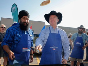 Conservative Leader Erin O'Toole flips a pancake at a breakfast in northeast Calgary as the Stampede gets underway in July. With a federal election nearing, Premier Jason Kenney's unpopularity could damage O'Toole's chances, says columnist Rob Breakenridge.