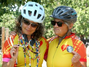 Dale Zukowski and Anne Cameron pose for a photo on the Bow River Pathway prior to an upcoming fundraiser. The bereaved parents of cancer victims doing a bike fundraiser for cancer research and plan to cycle from Banff to Lake Louise tomorrow. Saturday, July 17, 2021. Brendan Miller/Postmedia