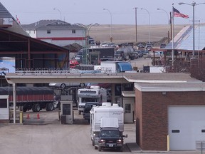 Vehicles line up at the Coutts, Alta., border crossing in this file photo.