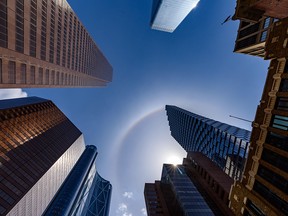 A halo around the sun shines above skyscrapers in downtown Calgary.
