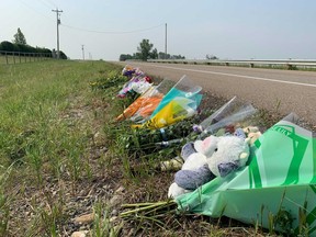 Flowers are seen at the scene of a single-vehicle accident that claimed the lives of two teens in Springbank. Dylan Short / Postmedia