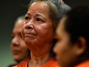 A member of a B.C. Indigenous community reacts at a presentation of the findings on 215 unmarked graves discovered at Kamloops Indian Residential School in Kamloops.